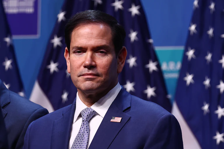 Secretary of State Marco Rubio stands on stage during a NATO summit.