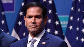 Secretary of State Marco Rubio stands on stage during a NATO summit