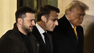France's President Emmanuel Macron walks with president-elect Donald Trump and Ukraine's President Volodymyr Zelensky after a meeting at the Elysee Presidential Palace in Paris on December 7, 2024.