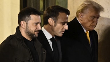 France's President Emmanuel Macron walks with president-elect Donald Trump and Ukraine's President Volodymyr Zelensky after a meeting at the Elysee Presidential Palace in Paris on December 7, 2024.