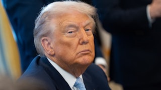 Donald Trump sits at his desk in the Oval Office