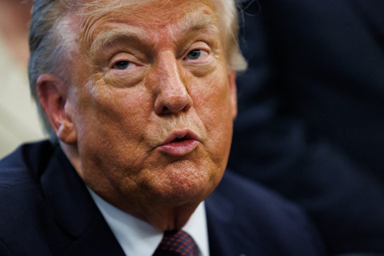 Donald Trump puckers his lips while speaking in the Oval Office