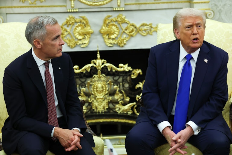 Donald Trump speaks while sitting next to Canadian Prime Minister Mark Carney in the Oval Office