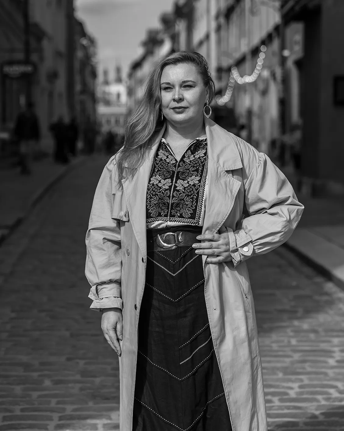 A black and white portrait of Vitaliia Dubrovska, a refugee originally from Kyiv, taken in Warsaw’s old city where she is living as a refugee.