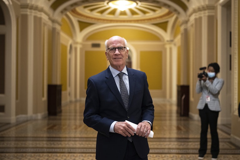 Vermont Senator Peter Welch walks through the hallways of the Senate at the U.S. Capitol.