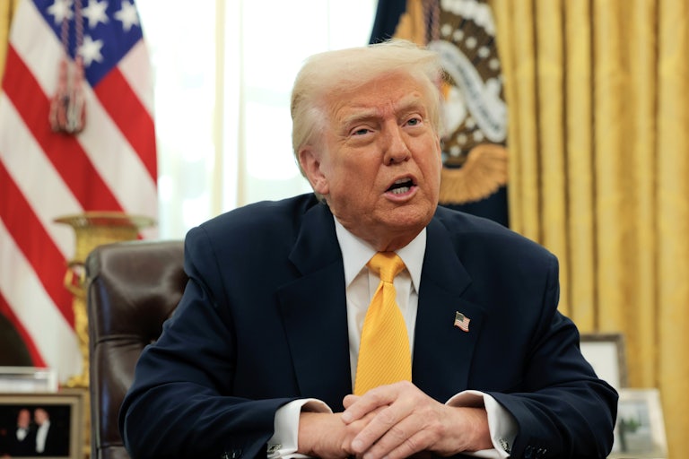 Donald Trump speaks while seated at his desk the White House’s Oval Office.