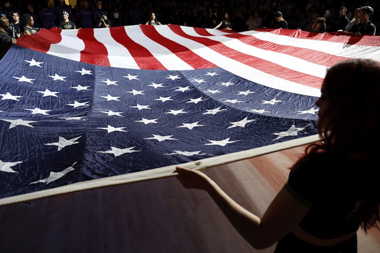 People hold a giant U.S. flag