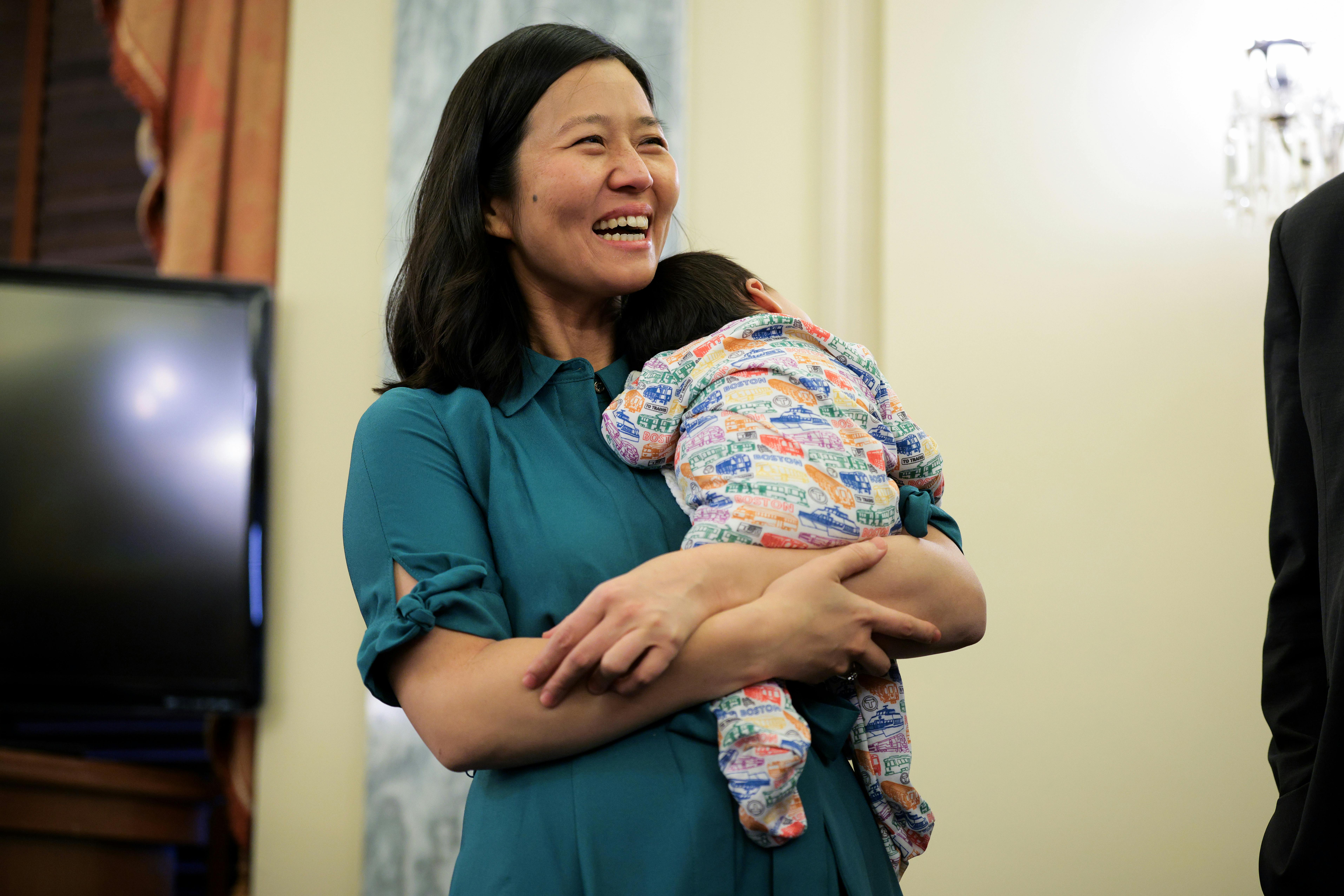 Boston Mayor Michelle Wu holds her baby before a press conference