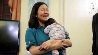 Boston Mayor Michelle Wu holds her baby before a press conference