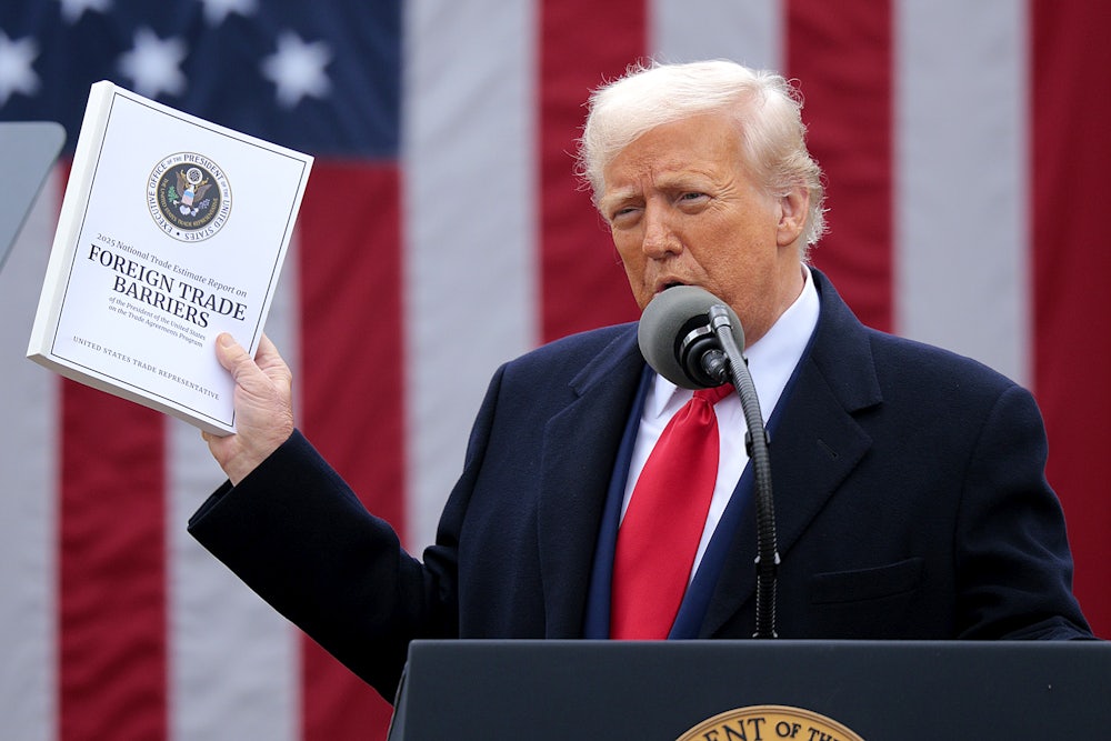 Donald Trump holds up a copy of a 2025 National Trade Estimate Report as he speaks during a “Make America Wealthy Again” trade announcement event in the Rose Garden at the White House.