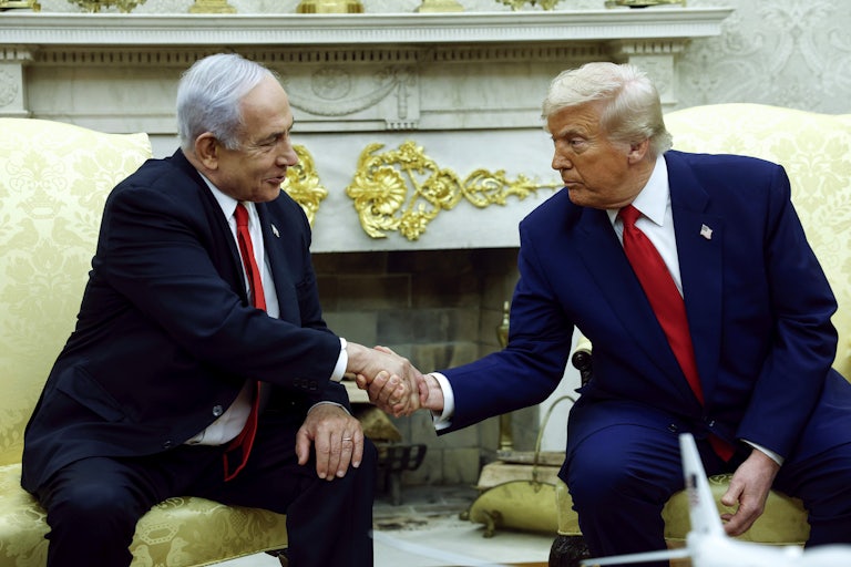 Israeli Prime Minister Benjamin Netanyahu and Donald Trump shake hands while sitting in the Oval Office