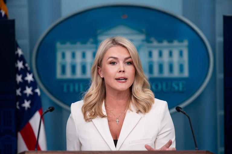 Karoline Leavitt speaks behind the lectern in the White House press briefing room.