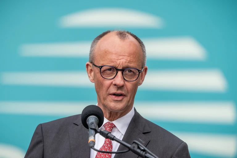 German Chancellor Friedrich Merz speaks into a microphone.