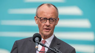 German Chancellor Friedrich Merz speaks into a microphone.
