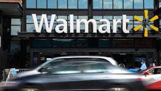 Cars speed by the front of a Walmart store in Washington, DC.