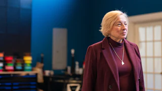 stands in partial profile to the camera during a campaign event