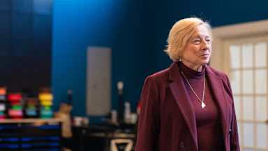 stands in partial profile to the camera during a campaign event