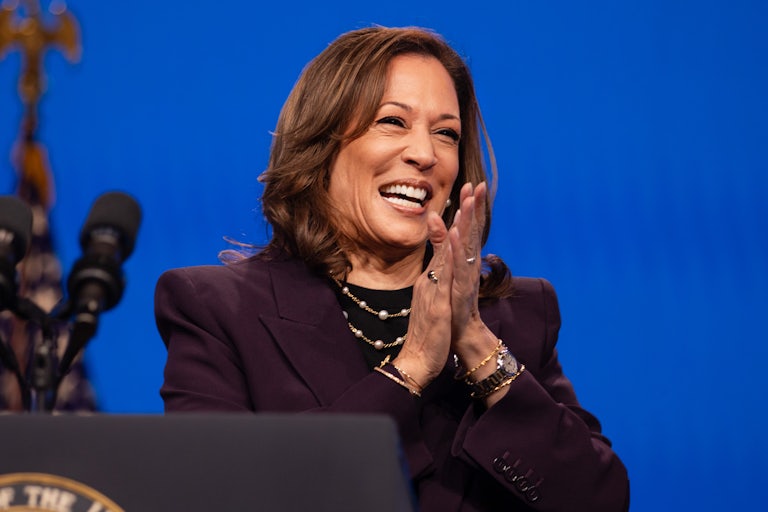 Kamala Harris smiles and claps