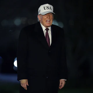 Donald Trump speaks while standing outside the White House