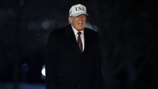Donald Trump speaks while standing outside the White House