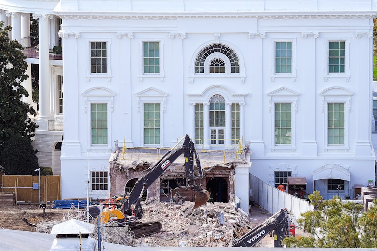 A bulldozer tears down part of the White House.