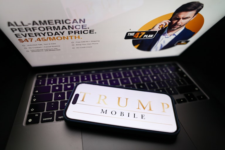 In this photo illustration, the Trump Mobile website displayed on a laptop screen and Trump Mobile logo displayed on a phone screen.