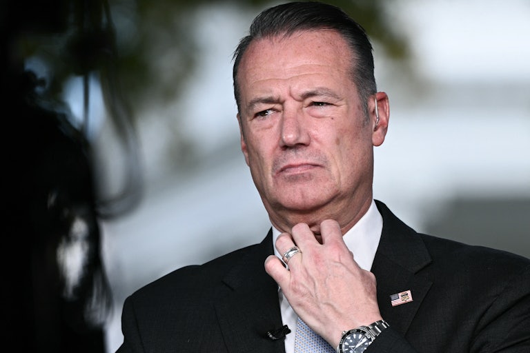 Acting ICE Director Todd Lyons readjusts his neck tie.