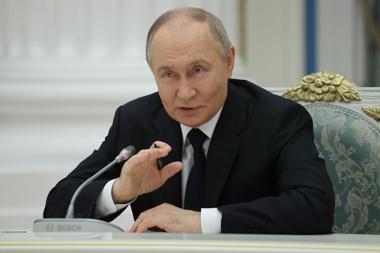Russian President Vladimir Putin gestures as he speaks during a meeting.