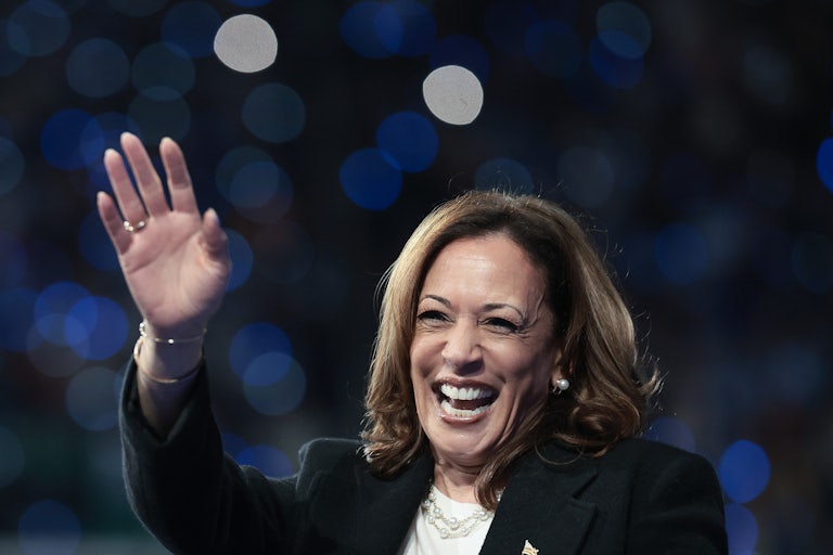 Vice President Kamala Harris waves a hand and laughs