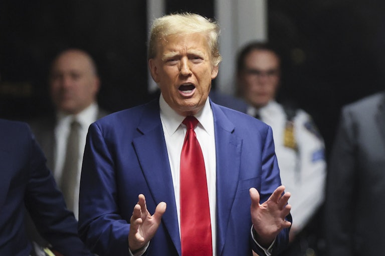 Donald Trump speaks and gestures with his hands