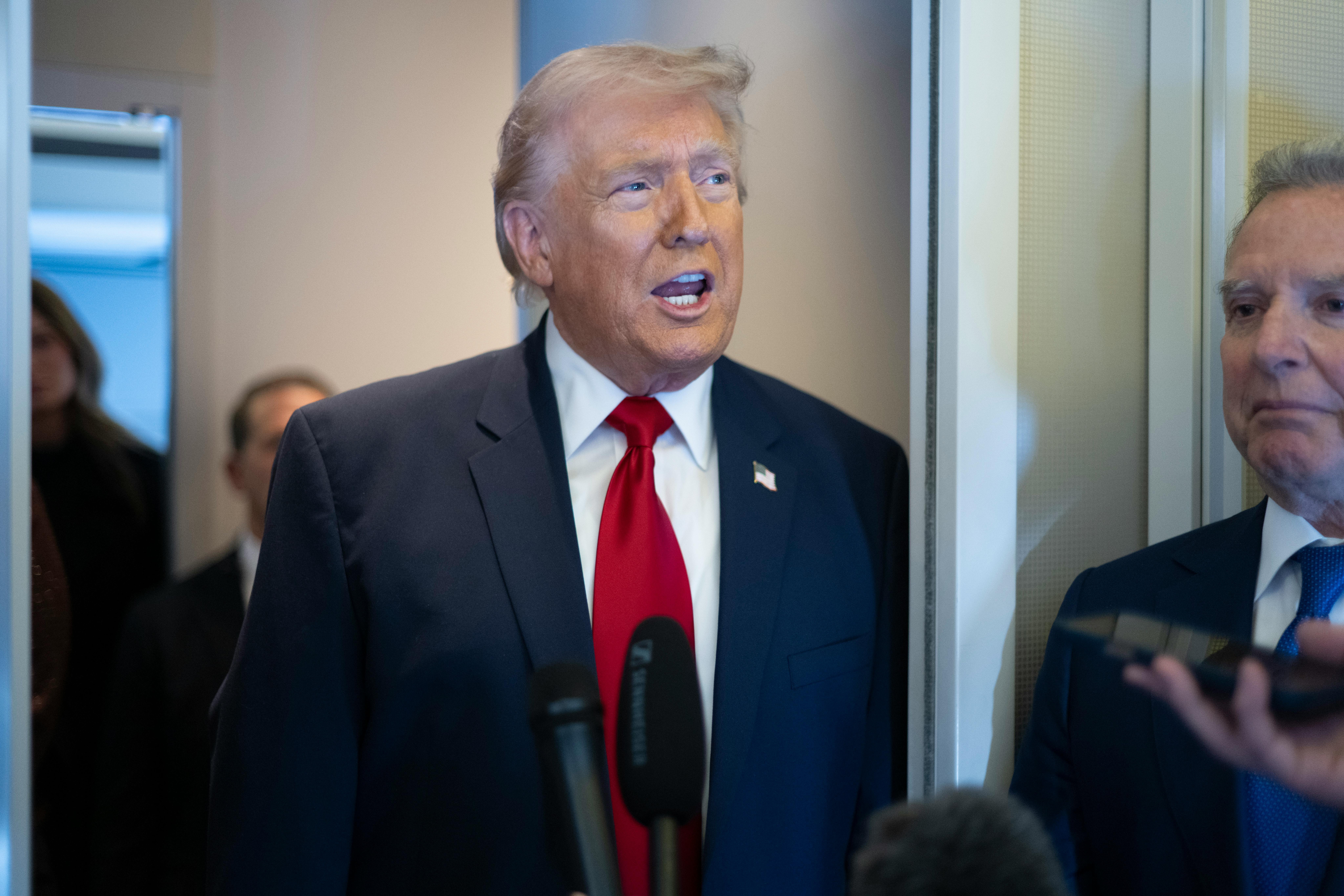 President Donald Trump speaks aboard Air Force One with Steve Witkoff at his side