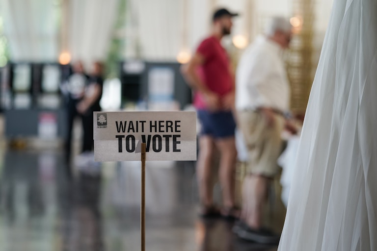 A sign that says “Wait here to vote” at a polling station in Georgia