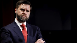 JD Vance with his arms crossed, looking kind of angry