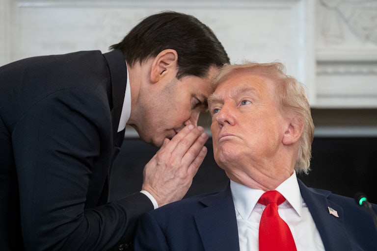 Secretary of State Marco Rubio whispers in Donald Trump's ear
