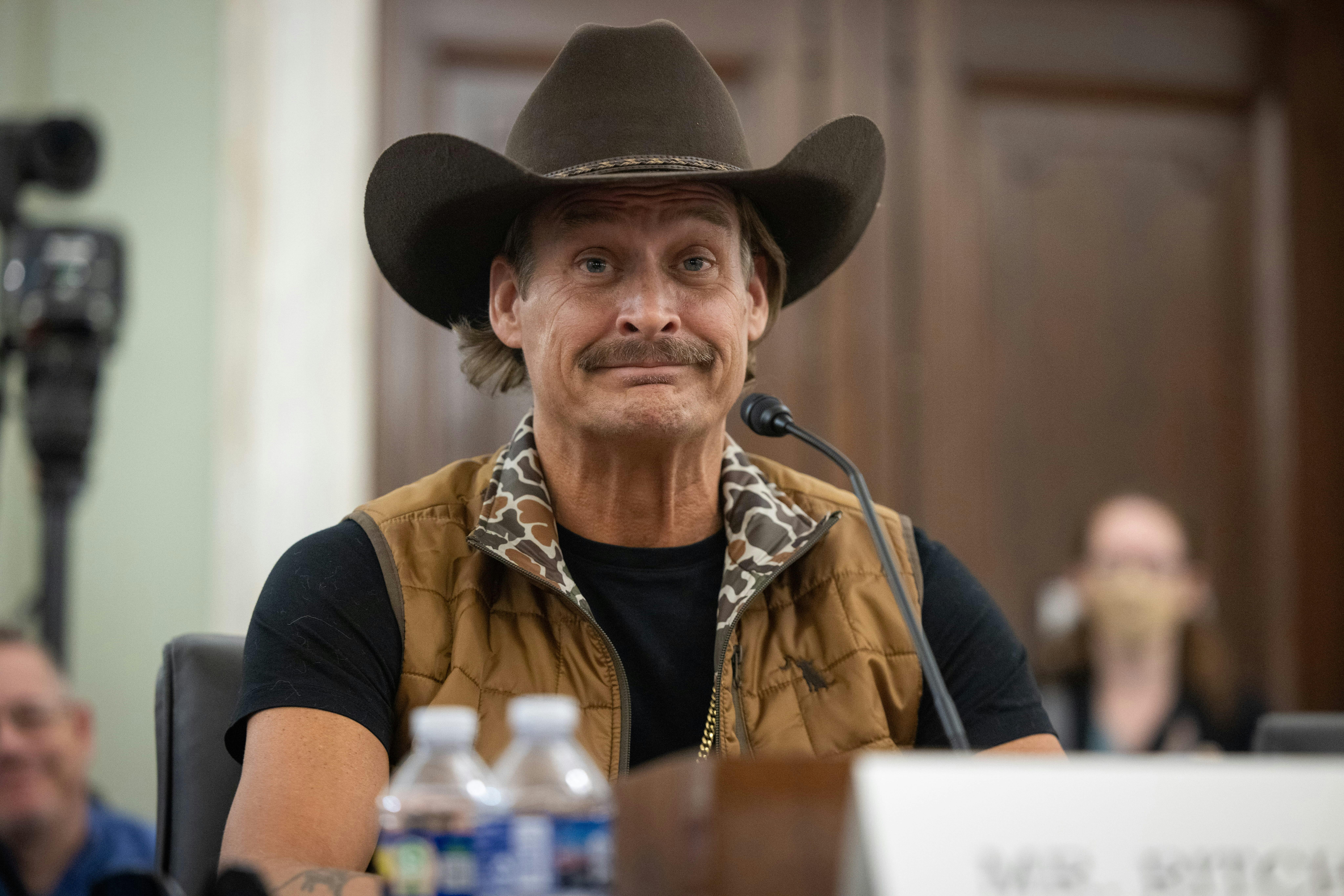 Kid Rock sits at a microphone in a Senate hearing
