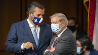 A masked Ted Cruz and Lindsey Graham have a discussion on Capitol Hill.