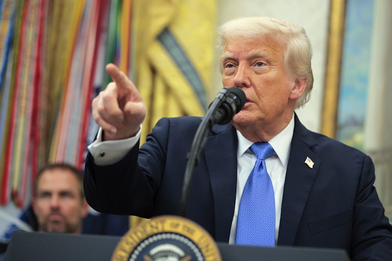 Donald Trump points while speaking at the presidential podium in the White House.