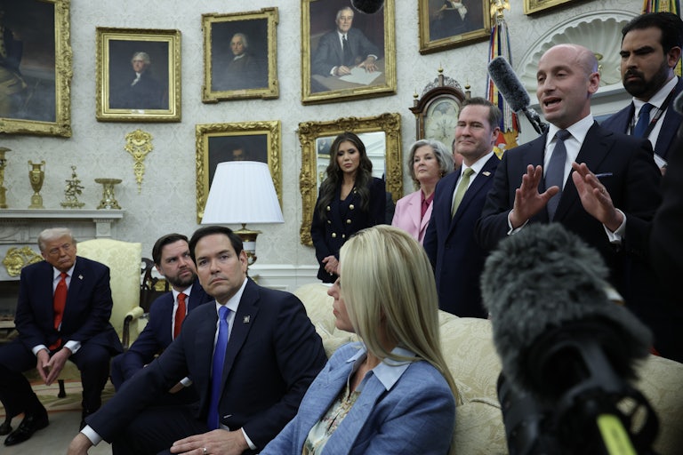 Stephen Miller speaks in the Oval Office of the White House, as Attorney General Pam Bondi, Susie Wiles, DHS Secretary Kristie Noem, Secretary of State Marco Rubio, and Donald Trump listen.