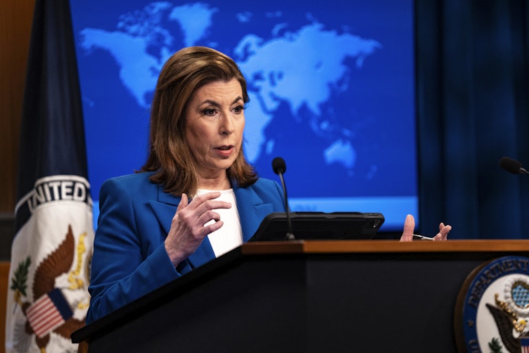 State Department spokeswoman Cindy McCain speaks behind a podium.