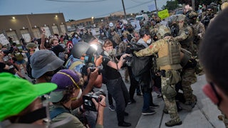 Federal agents violently confront protesters as reporters capture the scene.