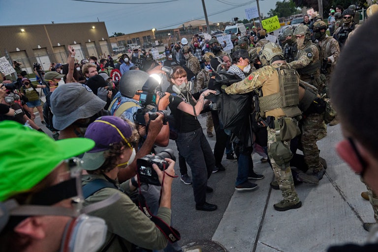 Federal agents violently confront protesters as reporters capture the scene.