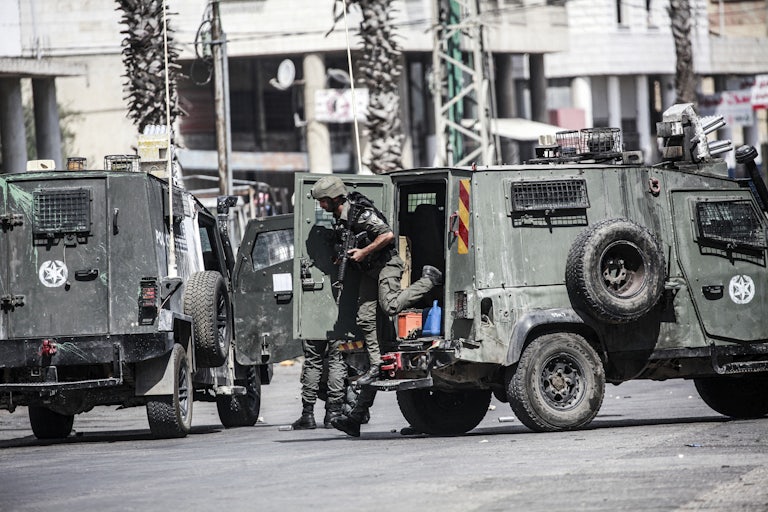 Israeli Defense Force soldiers near military vehicles