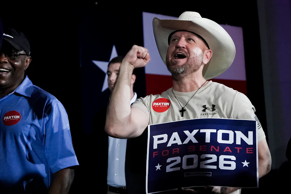 Supporter Samuel Hall of United Patriots of America cheers Texas Attorney General Ken Paxton, and U.S. Senate candidate, during a primary runoff election night watch party in Plano, Tuesday, May 26, 2026.