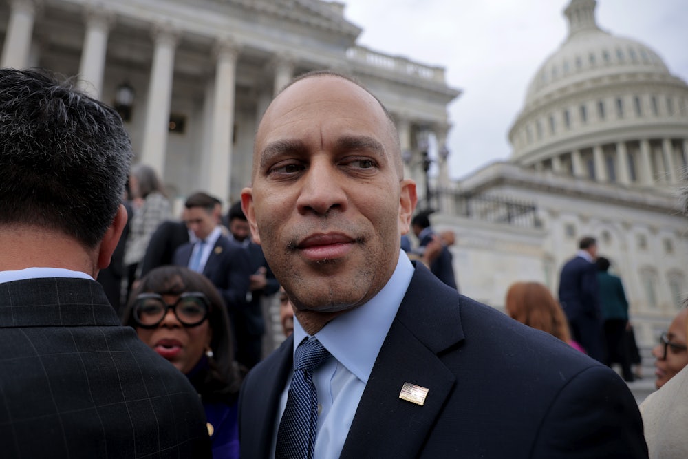 Hakeem Jeffries looks back as he stands in front of the US Capitol.