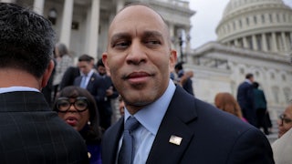 Hakeem Jeffries looks back as he stands in front of the US Capitol.