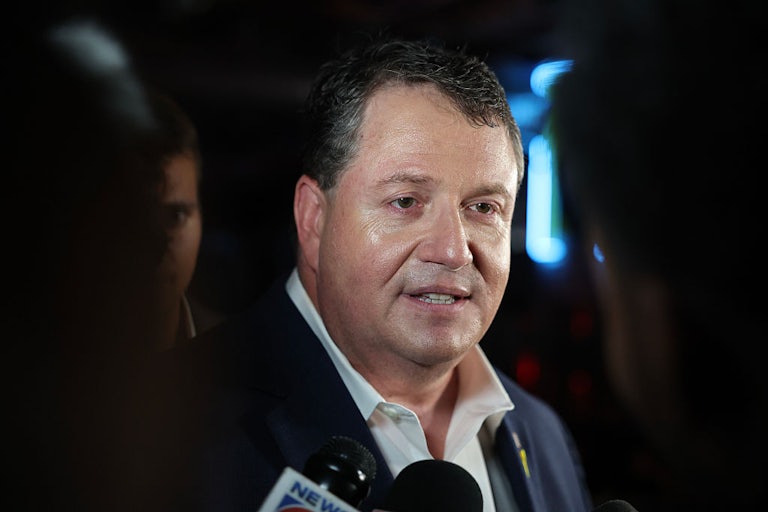 Representative Randy Fine speaks to reporters. (He is sweaty in this photo.)