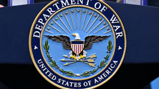 A "Department of War" seal on a podium