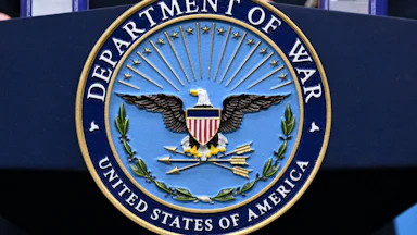 A "Department of War" seal on a podium