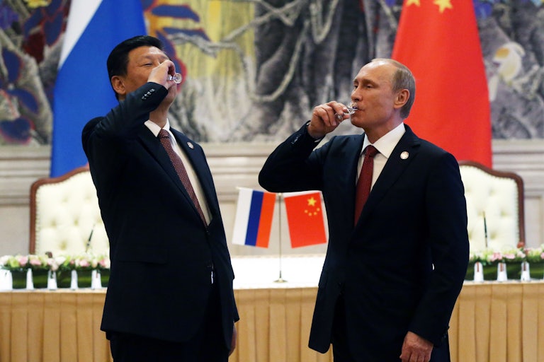 Putin and Xi toast with vodka