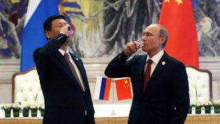 Putin and Xi toast with vodka
